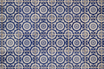 Wall with traditional Portuguese decor tiles azulezhu in blue tones.