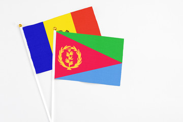 Eritrea and Moldova stick flags on white background. High quality fabric, miniature national flag. Peaceful global concept.White floor for copy space.
