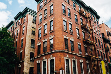 Tall vintage building with expensive apartment for rent located in brooklyn district, red stone urban architecture construction exterior with windows for residence housing on old historical street . - obrazy, fototapety, plakaty