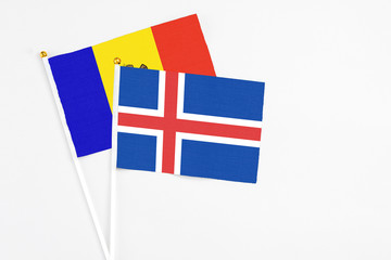 Obraz premium Iceland and Moldova stick flags on white background. High quality fabric, miniature national flag. Peaceful global concept.White floor for copy space.