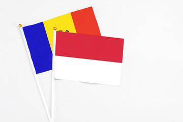 Indonesia and Moldova stick flags on white background. High quality fabric, miniature national flag. Peaceful global concept.White floor for copy space.