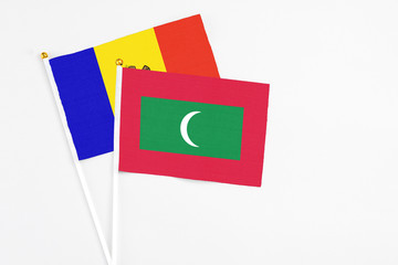 Maldives and Moldova stick flags on white background. High quality fabric, miniature national flag. Peaceful global concept.White floor for copy space.