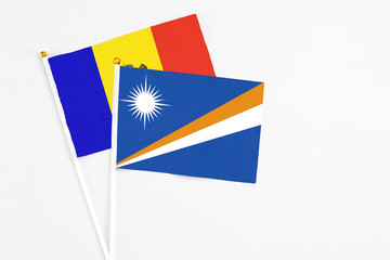 Marshall Islands and Moldova stick flags on white background. High quality fabric, miniature national flag. Peaceful global concept.White floor for copy space.