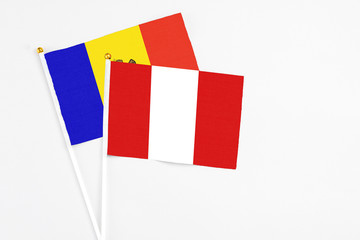 Peru and Moldova stick flags on white background. High quality fabric, miniature national flag. Peaceful global concept.White floor for copy space.