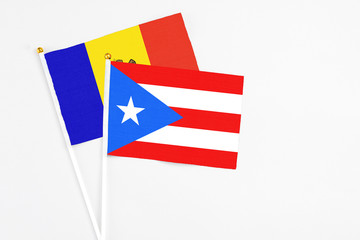 Puerto Rico and Moldova stick flags on white background. High quality fabric, miniature national flag. Peaceful global concept.White floor for copy space.
