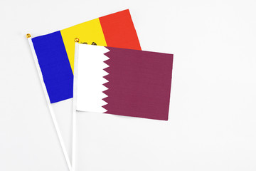 Qatar and Moldova stick flags on white background. High quality fabric, miniature national flag. Peaceful global concept.White floor for copy space.