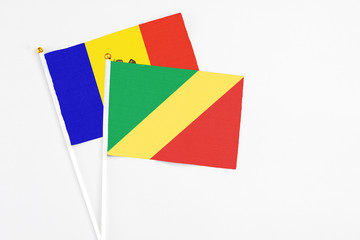 Republic Of The Congo and Moldova stick flags on white background. High quality fabric, miniature national flag. Peaceful global concept.White floor for copy space.