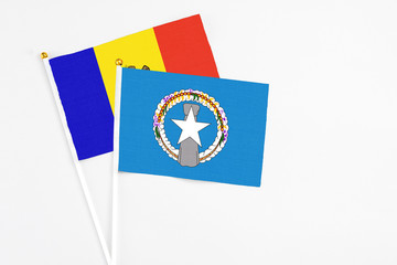 Northern Mariana Islands and Moldova stick flags on white background. High quality fabric, miniature national flag. Peaceful global concept.White floor for copy space.