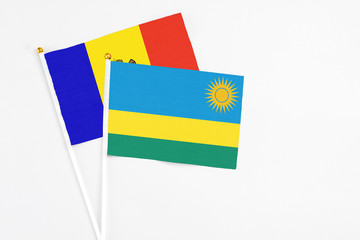 Rwanda and Moldova stick flags on white background. High quality fabric, miniature national flag. Peaceful global concept.White floor for copy space.