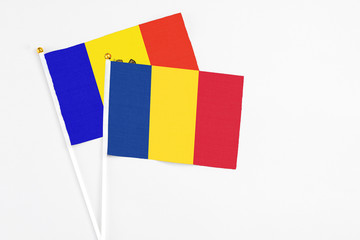 Romania and Moldova stick flags on white background. High quality fabric, miniature national flag. Peaceful global concept.White floor for copy space.