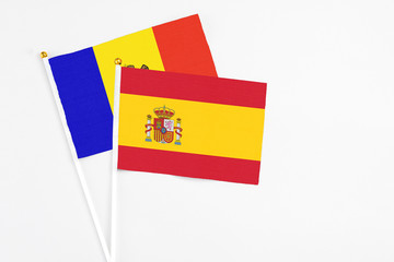 Spain and Moldova stick flags on white background. High quality fabric, miniature national flag. Peaceful global concept.White floor for copy space.