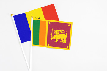 Sri Lanka and Moldova stick flags on white background. High quality fabric, miniature national flag. Peaceful global concept.White floor for copy space.