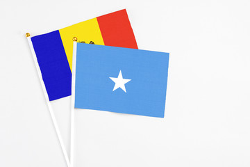 Somalia and Moldova stick flags on white background. High quality fabric, miniature national flag. Peaceful global concept.White floor for copy space.