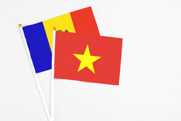 Vietnam and Moldova stick flags on white background. High quality fabric, miniature national flag. Peaceful global concept.White floor for copy space.