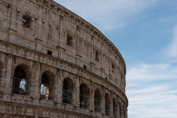Obraz premium Part of the Colosseum in Rome, Italy with blue sky in the background. 
