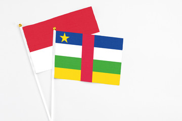 Central African Republic and Monaco stick flags on white background. High quality fabric, miniature national flag. Peaceful global concept.White floor for copy space.