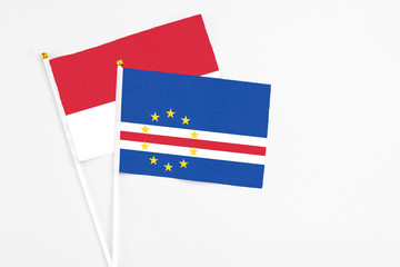 Cape Verde and Monaco stick flags on white background. High quality fabric, miniature national flag. Peaceful global concept.White floor for copy space.