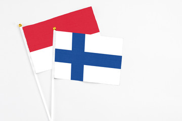 Finland and Monaco stick flags on white background. High quality fabric, miniature national flag....