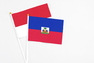 Haiti and Monaco stick flags on white background. High quality fabric, miniature national flag....