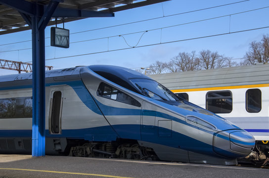 KOLOBRZEG, WEST POMERANIAN / POLAND - APRIL, 2016: Express train waiting for passengers at the platform at the train station