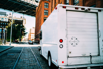 White van automobile for transportation or shipping of logistic company parked on urban setting,...