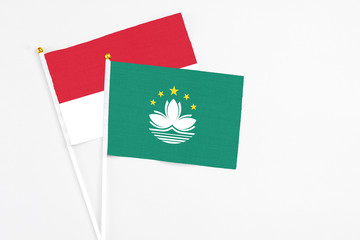 Macao and Monaco stick flags on white background. High quality fabric, miniature national flag. Peaceful global concept.White floor for copy space.