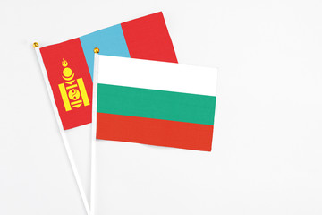 Bulgaria and Mongolia stick flags on white background. High quality fabric, miniature national flag. Peaceful global concept.White floor for copy space.