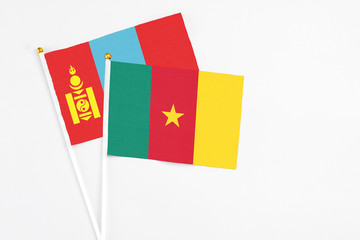 Cameroon and Mongolia stick flags on white background. High quality fabric, miniature national flag. Peaceful global concept.White floor for copy space.