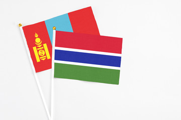 Gambia and Mongolia stick flags on white background. High quality fabric, miniature national flag. Peaceful global concept.White floor for copy space.