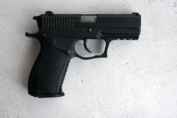 9mm Jorge Handgun isolated on a gray background.