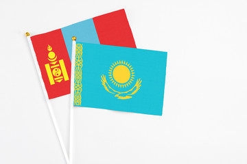 Kazakhstan and Mongolia stick flags on white background. High quality fabric, miniature national flag. Peaceful global concept.White floor for copy space.