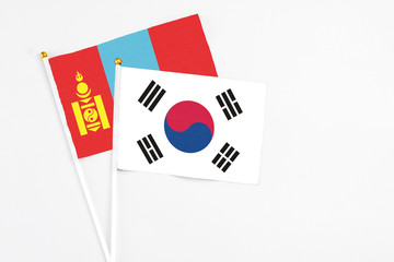 South Korea and Mongolia stick flags on white background. High quality fabric, miniature national flag. Peaceful global concept.White floor for copy space.