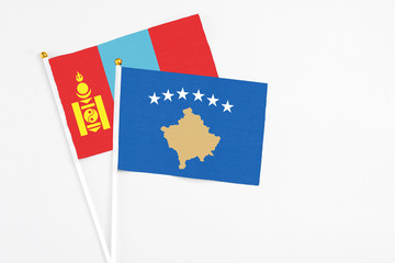 Kosovo and Mongolia stick flags on white background. High quality fabric, miniature national flag. Peaceful global concept.White floor for copy space.