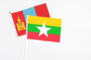 Myanmar and Mongolia stick flags on white background. High quality fabric, miniature national flag. Peaceful global concept.White floor for copy space.