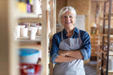 Portrait of senior female pottery artist in her art studio