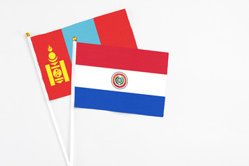 Paraguay and Mongolia stick flags on white background. High quality fabric, miniature national flag. Peaceful global concept.White floor for copy space.