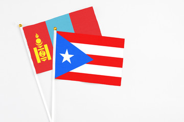 Puerto Rico and Mongolia stick flags on white background. High quality fabric, miniature national flag. Peaceful global concept.White floor for copy space.