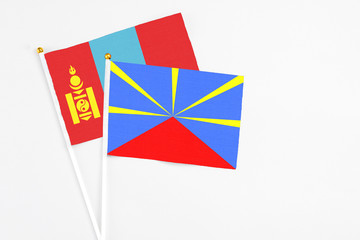 Reunion and Mongolia stick flags on white background. High quality fabric, miniature national flag. Peaceful global concept.White floor for copy space.