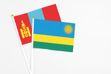 Rwanda and Mongolia stick flags on white background. High quality fabric, miniature national flag. Peaceful global concept.White floor for copy space.