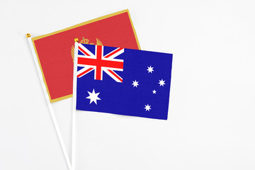 Australia and Montenegro stick flags on white background. High quality fabric, miniature national flag. Peaceful global concept.White floor for copy space.