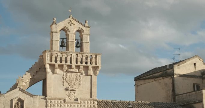 Materdomini Church in Piazza Vittorio Veneto of Matera. Built flat bell tower with balustrade in beige tuff.