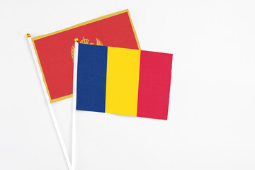 Chad and Montenegro stick flags on white background. High quality fabric, miniature national flag. Peaceful global concept.White floor for copy space.