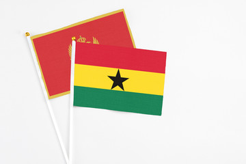 Ghana and Montenegro stick flags on white background. High quality fabric, miniature national flag. Peaceful global concept.White floor for copy space.