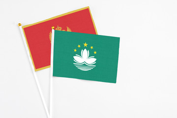 Macao and Montenegro stick flags on white background. High quality fabric, miniature national flag. Peaceful global concept.White floor for copy space.