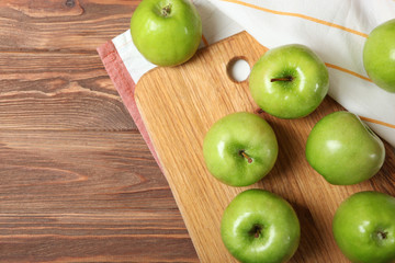 juicy green apples on a wooden table.