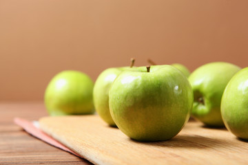 juicy green apples on a wooden table.