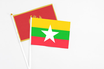 Myanmar and Montenegro stick flags on white background. High quality fabric, miniature national flag. Peaceful global concept.White floor for copy space.