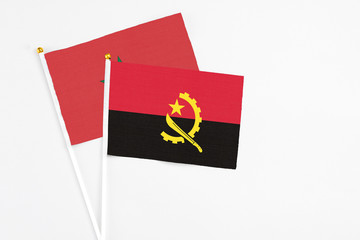 Angola and Morocco stick flags on white background. High quality fabric, miniature national flag. Peaceful global concept.White floor for copy space.