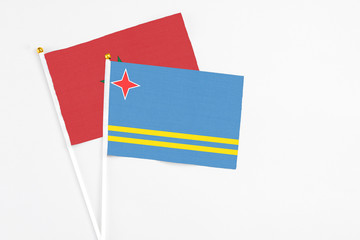 Aruba and Morocco stick flags on white background. High quality fabric, miniature national flag. Peaceful global concept.White floor for copy space.