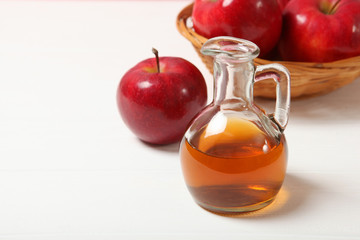 apples and apple cider vinegar on the table.